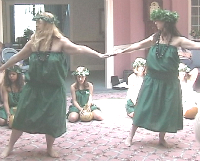 Bev "Peweli" and student dance in green dresses