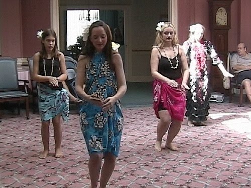 Instructor and students performing hula